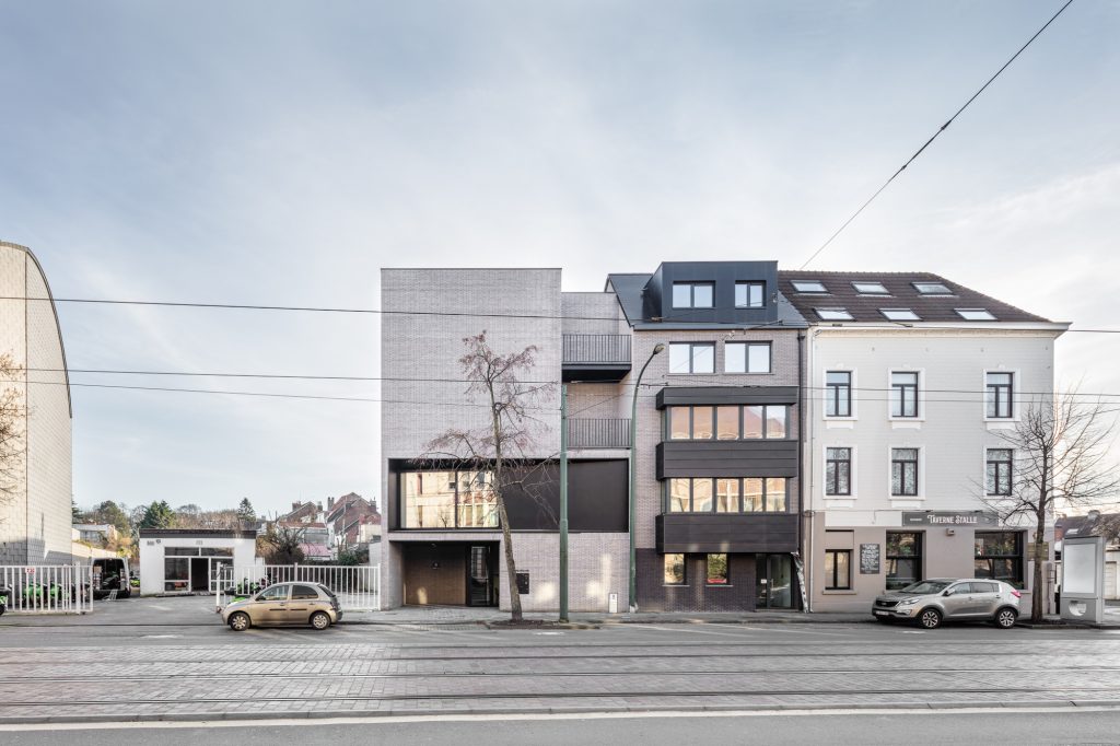 Façades de bâtiments modernes et anciens juxtaposés, avec tramway passant devant